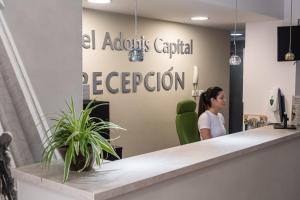 a woman sitting at a reception desk in a office at Hotel Adonis Capital in Santa Cruz de Tenerife