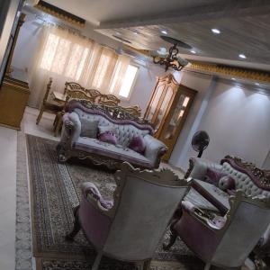 a living room with a couch and chairs at شقة مفروشة سوبر لوكس للايجار in Cairo