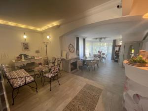 a living room with chairs and a dining room at Villa Rose Garden in Nyíregyháza