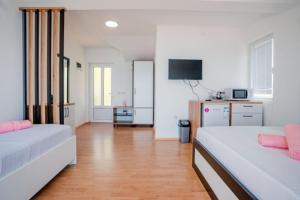 a living room with two beds and a television at VILA PUPA, Elešec 2 in Ohrid