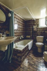 a bathroom with a tub and a toilet and a sink at 7th floor penthouse in the heart of Thessaloníki in Thessaloniki