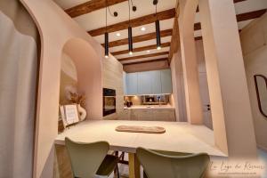 a kitchen and dining room with a table and chairs at La Loge du Rêveur - Spa - Vieux-Lyon in Lyon +11 photos