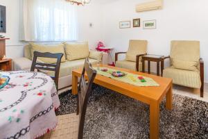 a living room with a table and chairs at Vacation Flat w Garden Patio BBQ in Mugla in Mugla