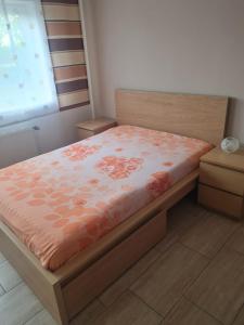 a bedroom with a bed with orange flowers on it at Appartement Willmeroth in Königswinter