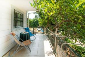 a patio with chairs and a table and a tree at Vacation Flat w Garden Patio BBQ in Mugla in Mugla