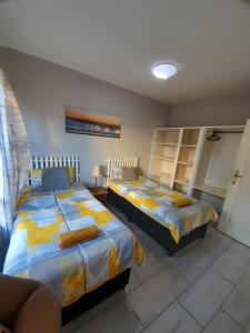 a bedroom with two beds in a room at Margate Sunset Apartments in Margate