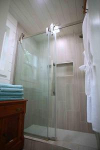 La salle de bains est pourvue d'une douche avec une porte en verre. dans l'établissement NEW Hilltop Cabin 35 min South of Nashville, à Columbia