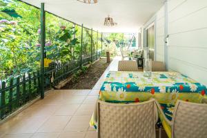 a patio with a table and chairs on a balcony at Vacation Flat w Pool Garden Patio BBQ in Mugla in Mugla