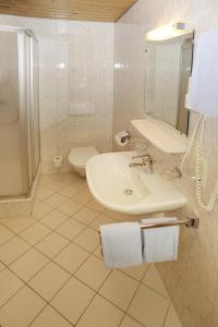 聖加倫基希的住宿－豪斯奧貝爾奧美茵公寓，白色的浴室设有水槽和卫生间。
