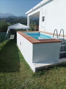 a swimming pool in the side of a house at Chania Mini Villas in Skinés