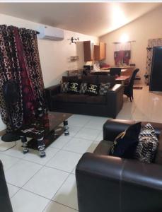a living room with two leather couches and a table at Leila VIllage Plus in Mendes