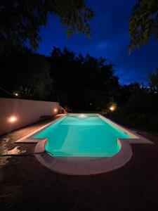 una piscina vuota di notte di La casa nel bosco a Lari