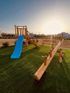 a playground with two slides and a blue slide at Villa Susca - villa sul mare in Monopoli