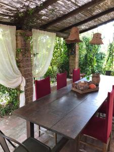 un tavolo e sedie in legno su un patio di La casa nel bosco a Lari