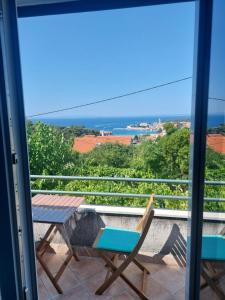 a view of the ocean from the balcony of a house at Apartment Roglić in Rab