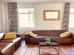 a living room with a couch and a table at Quiet holiday home in Valkenburg in Valkenburg