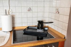 a coffee pot sitting on top of a kitchen sink at Theoni’s country house with garden and sea view in Alexandroupoli +14 photos