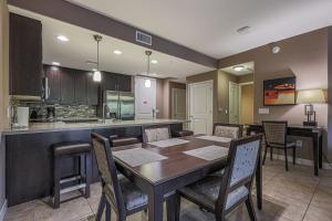 a dining room with a table and a kitchen at Villa Toscana condo in Phoenix