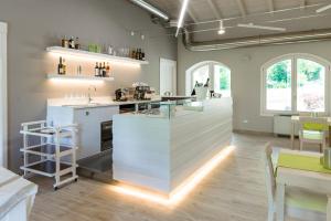 a large kitchen with a counter and a dining room at Bianco Hotel in Primaluna