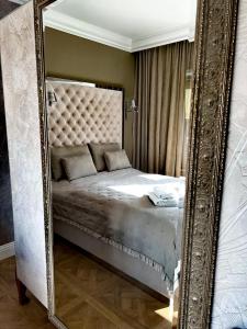 a mirror reflecting a bed in a room at Hotel Bellevue in Charzykowy