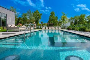 uma piscina com água azul em REED Luxury Hotel by Balaton em Siófok