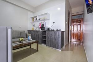 uma sala de estar com um sofá e uma mesa em Mashpark Apartments em Nairobi