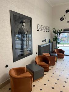 a waiting room with chairs and a picture of a man at GRAND KENT OTEL in Bilecik