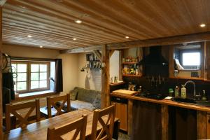 a kitchen with a counter and a couch in a room at Les Posettes, appartement Le Sizeray - Mont Blanc in Vallorcine