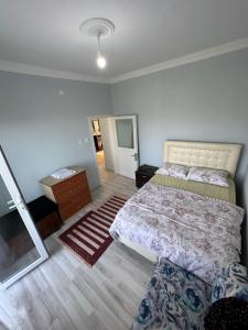 a bedroom with a bed and a dresser and a mirror at Xudisa Manzaram in Pazar