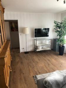 a living room with a flat screen tv on the wall at Ferienwohnung Eifel-Roedis in Blankenheim