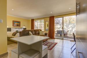 a living room with a couch and a bed at Edenvale Guest House in Edenvale
