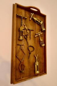 a wooden clock with different kinds of tools on it at Casa di Carla in Lauco