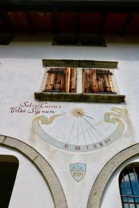 a clock on the side of a building at Casa di Carla in Lauco