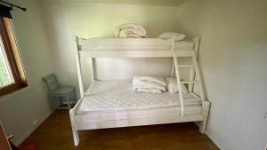Ce lit superposé blanc se trouve dans un dortoir. dans l'établissement EG Apartment, à Leknes