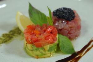 a piece of food on a white plate with fruit at Vannee Golden Sands Beachfront Resort in Haad Rin