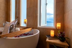 a bath tub in a bathroom with a window at Vannee Golden Sands Beachfront Resort in Haad Rin