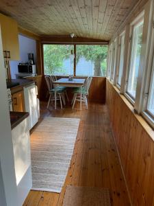 a kitchen and dining room with a table and chairs at Sjönära stuga in Norrtälje