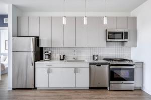 a kitchen with white cabinets and stainless steel appliances at West Loop 2br w theater gym nr restaurant row CHI-950 in Chicago