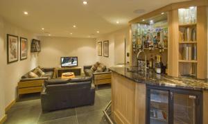 a bar in a living room with a couch at Chalet Cree - Haute Collection in Chamonix