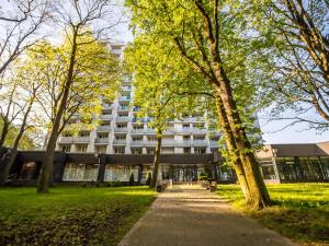 a building with trees in front of it at Sanatorium Perla Baltyku in Kołobrzeg