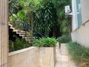 a garden with a staircase and plants in a building at Jade Waters Apt 02 in Candi