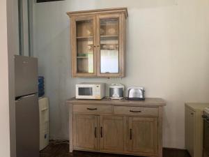 a kitchen with a cabinet and a microwave on a counter at Jade Waters Apt 02 in Candi