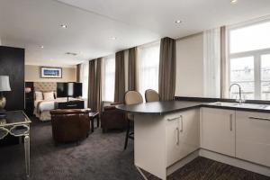 a hotel room with a kitchen and a bedroom at The Vermont Hotel & Vermont Aparthotel in Newcastle upon Tyne
