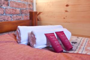 a pile of towels sitting on top of a bed at Cottages Big bear in Žabljak +27 photos