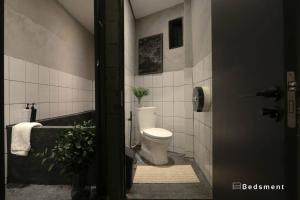 a bathroom with a toilet and a sink and a tub at Bedsment@Hayaek in Chiang Rai +27 photos