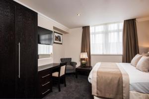 a hotel room with a bed and a desk at The Vermont Hotel & Vermont Aparthotel in Newcastle upon Tyne