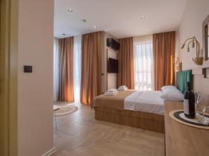 a hotel room with a bed and a desk in a room at Hotel Diman in Dobra Voda