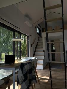 a room with a table with a laptop on it at Tiny House - Osada Wilkasy in Giżycko