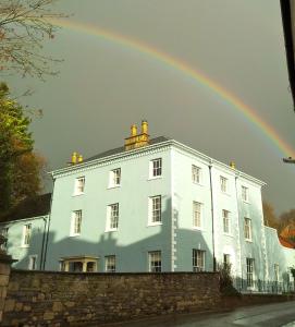 a rainbow in front of a white building at Bove Town House Apartments in Glastonbury