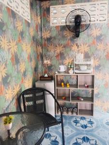 a dining room with a table and a fan at SK Hometel Samui Airport in Bang Rak Beach